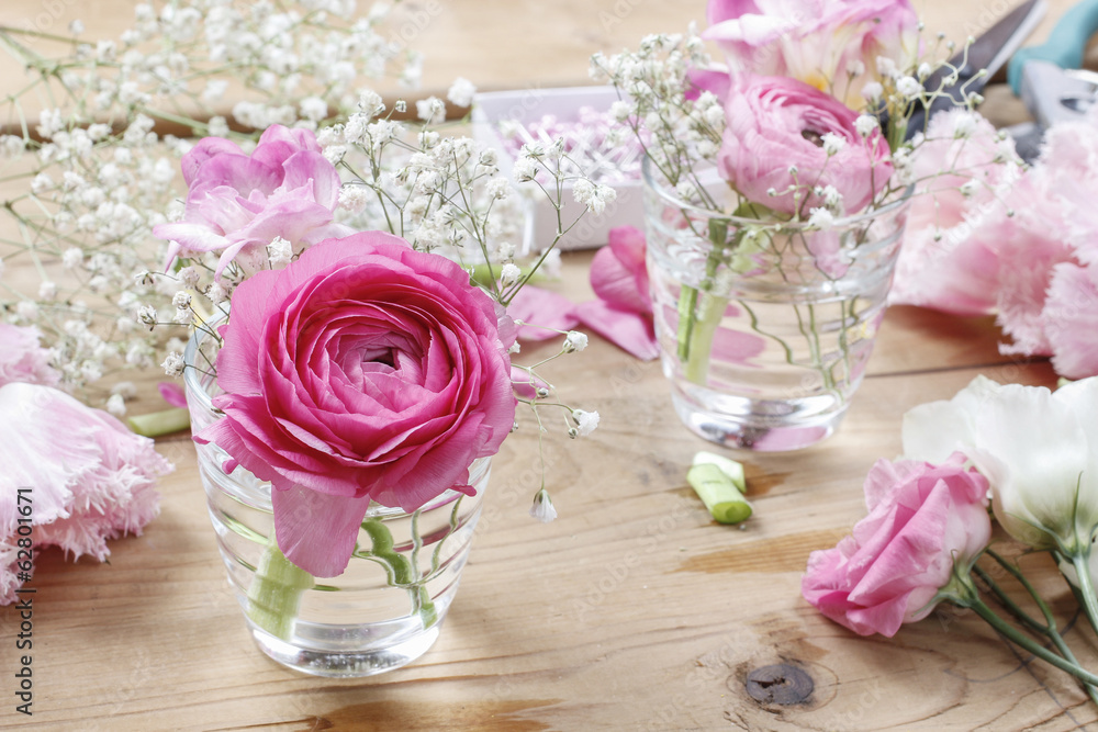 Florist workplace: incomplete tiny bouquets in glass vases. Step Florist workplace: incomplete tiny bouquets in glass vases. Step