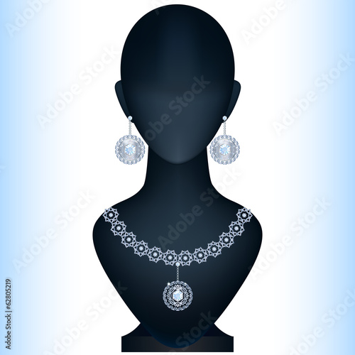 Mannequin with women's jewelery. Silver earrings and necklace wi