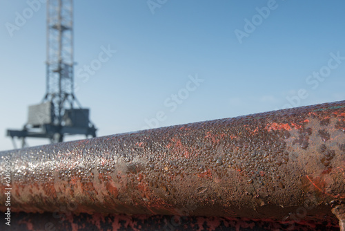 Closeup of a rusty tube with water droplets photo