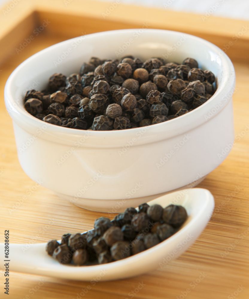Black pepper on wood background Black pepper on wood background