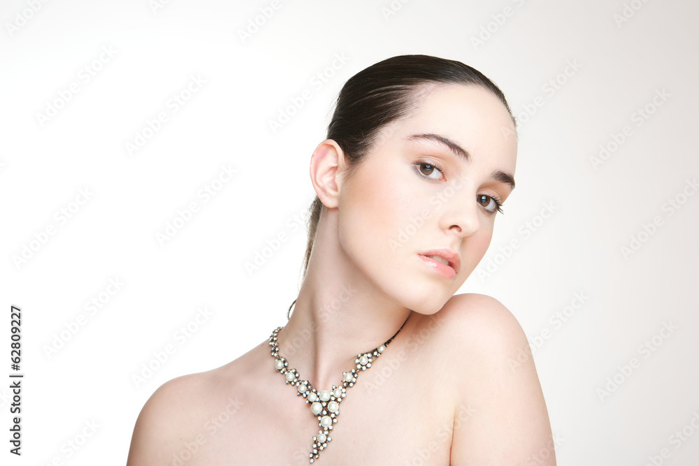 Beautiful young woman with necklace