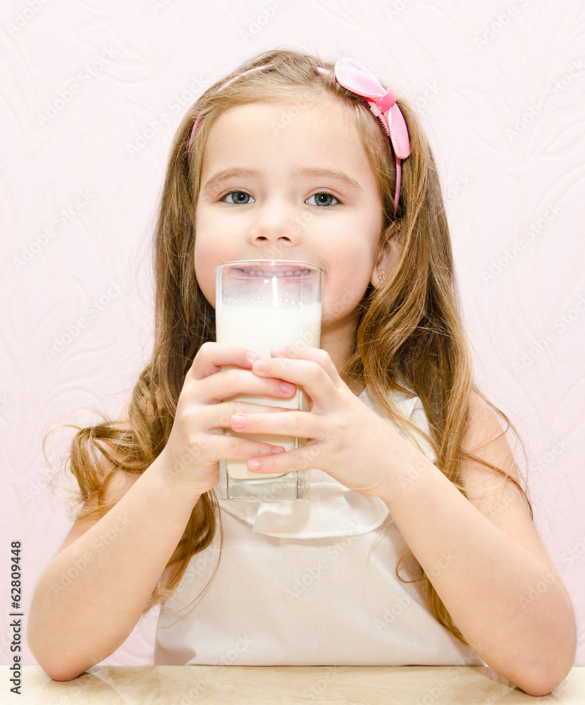 Beautiful smiling little girl drinking milk Beautiful smiling little girl drinking milk