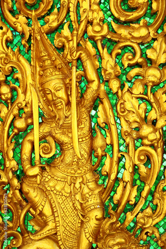 Fototapeta premium thai style golden carving art on the wall temple