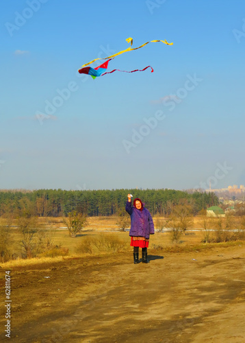 Happy elderly Woman Flying a Kite