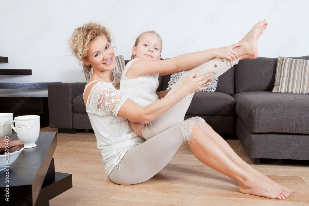 Mother and daughter doing yoga exercises Mother and daughter doing yoga exercises