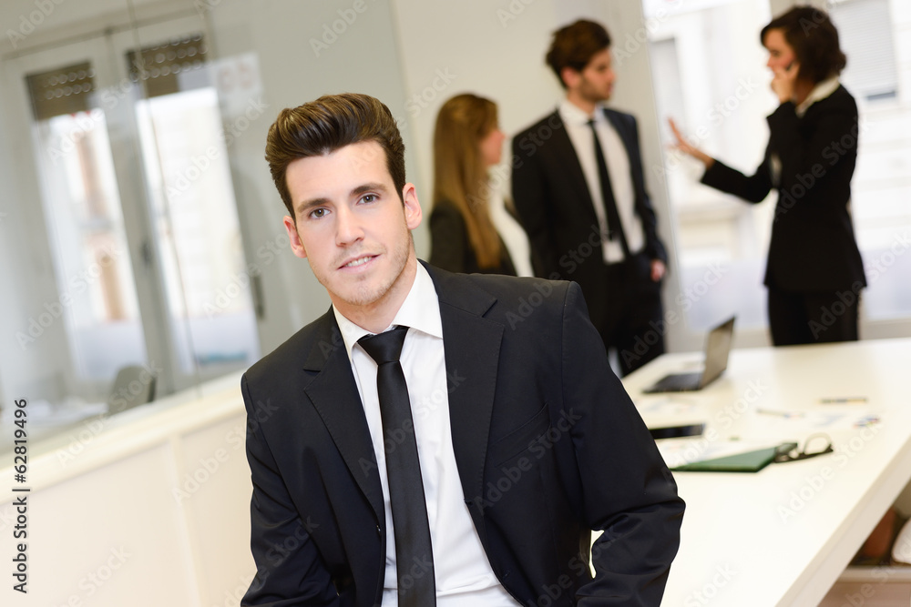 Business leader looking at camera in working environment Business leader looking at camera in working environment