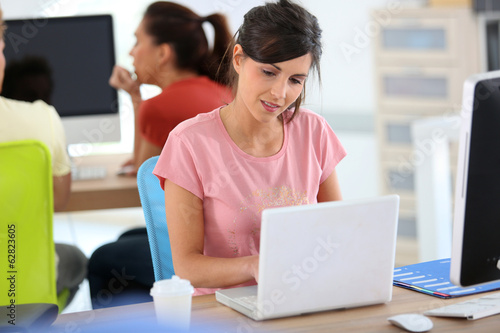 Young woman in business training with laptop