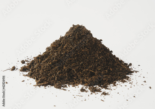 A pile of organic compost on a white background. 