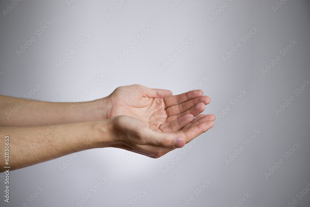 Male hands on a gray background