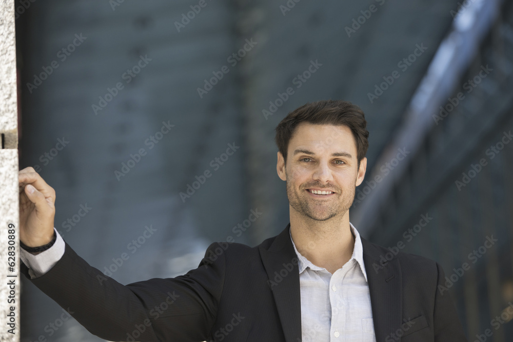 Business people in the city. Keeping in touch on the move. A man in a black jacket and open collared shirt. Business people in the city. Keeping in touch on the move. A man in a black jacket and open collared shirt.