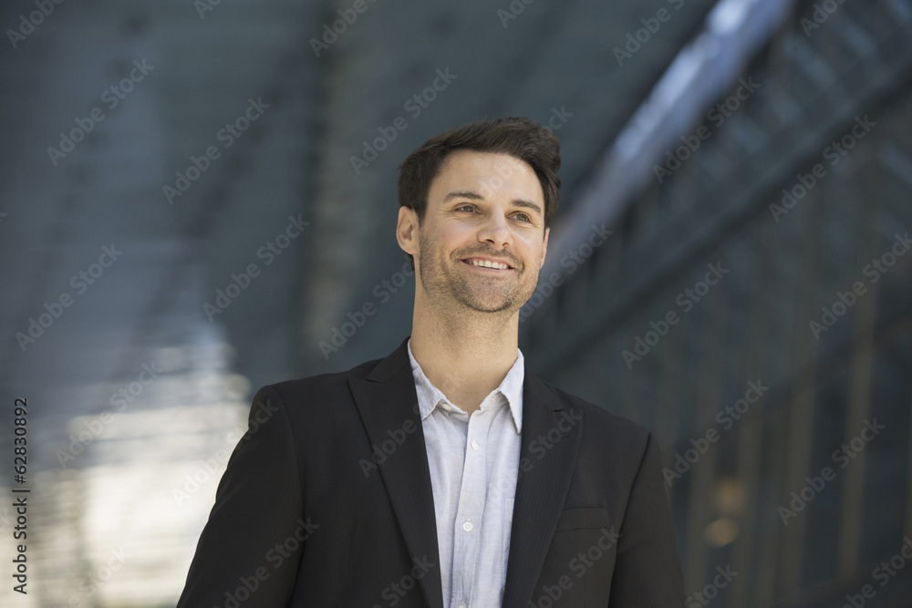 Business people in the city. Keeping in touch on the move. A man in a black jacket and open collared shirt. Business people in the city. Keeping in touch on the move. A man in a black jacket and open collared shirt.