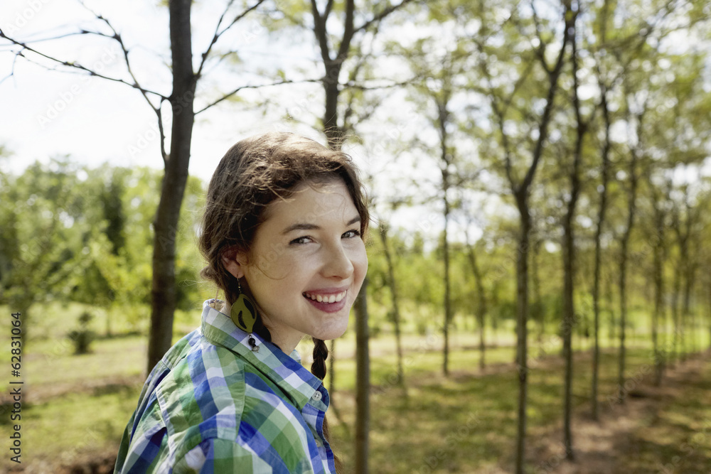 A girl in a green checked shirt with braids. A girl in a green checked shirt with braids.