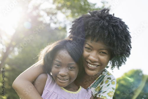 A young woman and a child hugging.