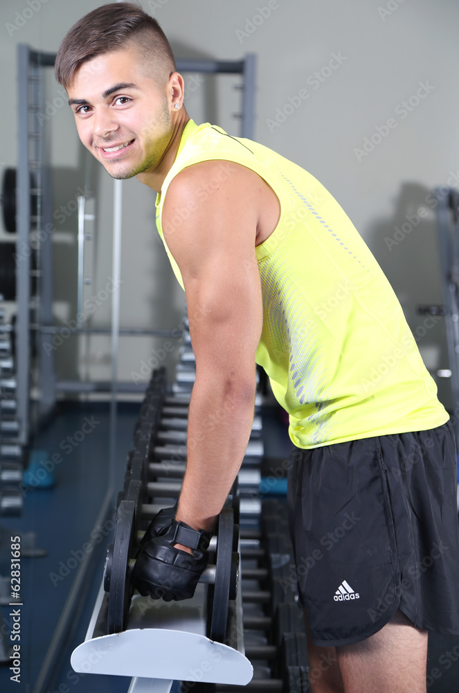 Guy with dumbbells in gym Guy with dumbbells in gym