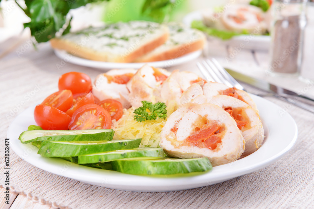 Delicious chicken roll on plate on table close-up