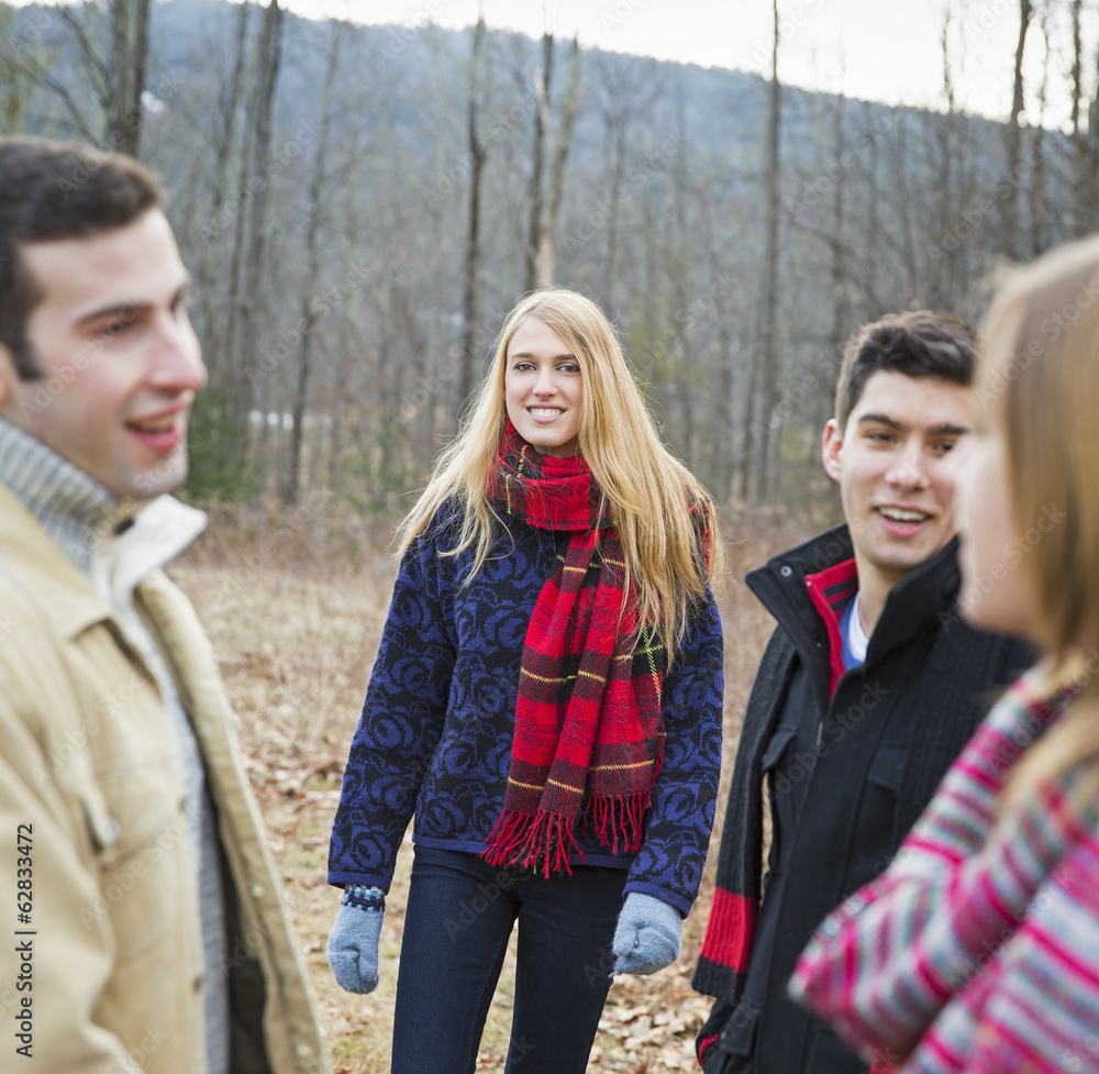 A group of four people outdoors on a winter day. 