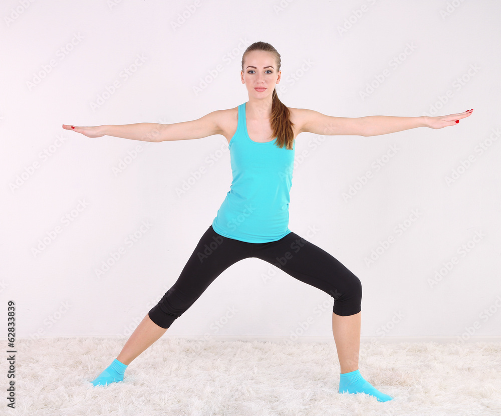 Young beautiful fitness girl exercising in gym Young beautiful fitness girl exercising in gym