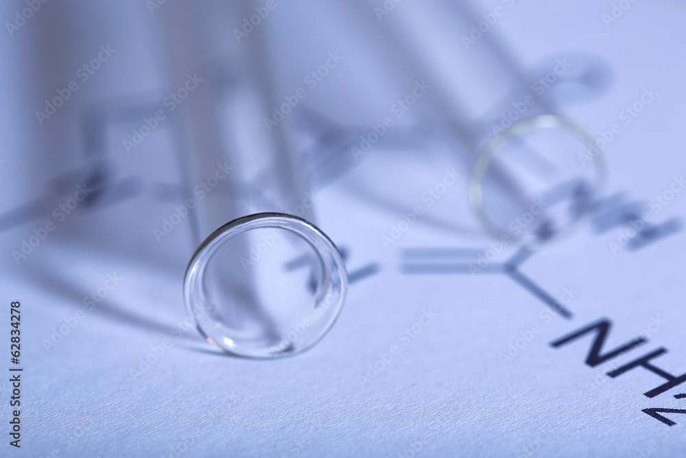 Test tubes and reaction formula, close-up Test tubes and reaction formula, close-up