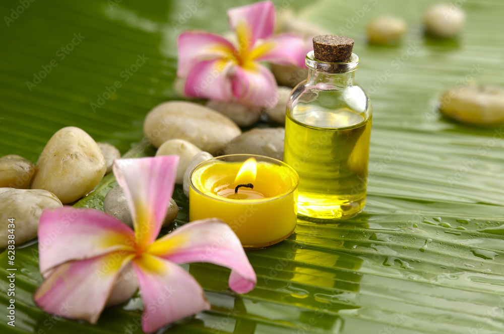 spa with massage oil and two pink orchid,candle on leaf