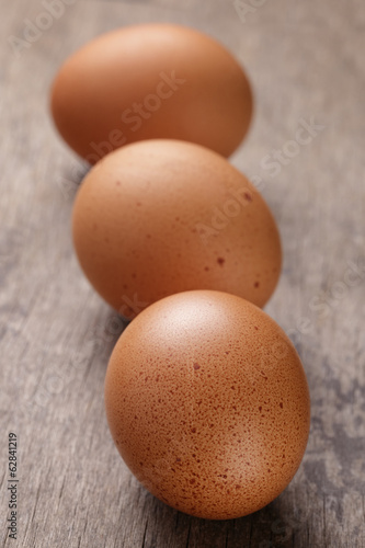 speckled chicken eggs on old table