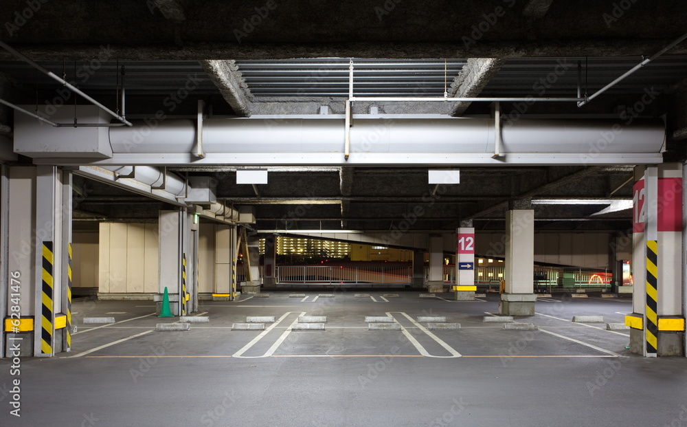 Parking garage underground interior, neon lights in dark Parking garage underground interior, neon lights in dark