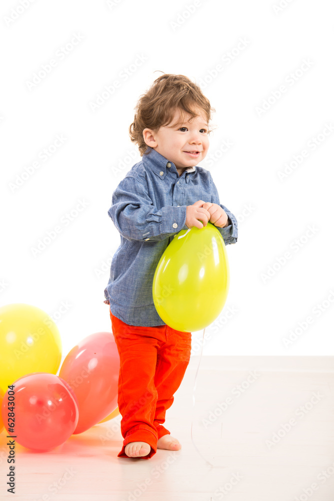 Toddler walking with balloon Toddler walking with balloon