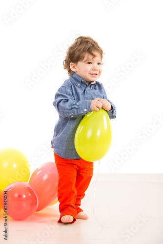 Toddler walking with balloon