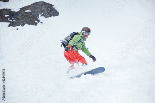 Female snowboarder at the mountains