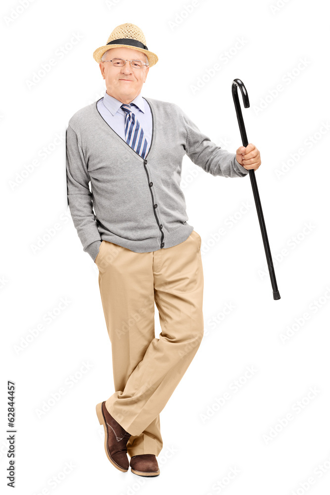 Senior gentleman with cane, leaning against a wall Senior gentleman with cane, leaning against a wall