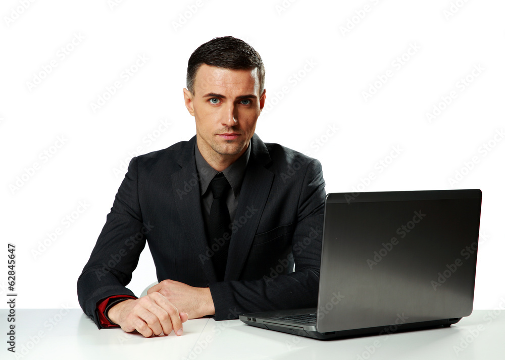 Confident businessman working on laptop 