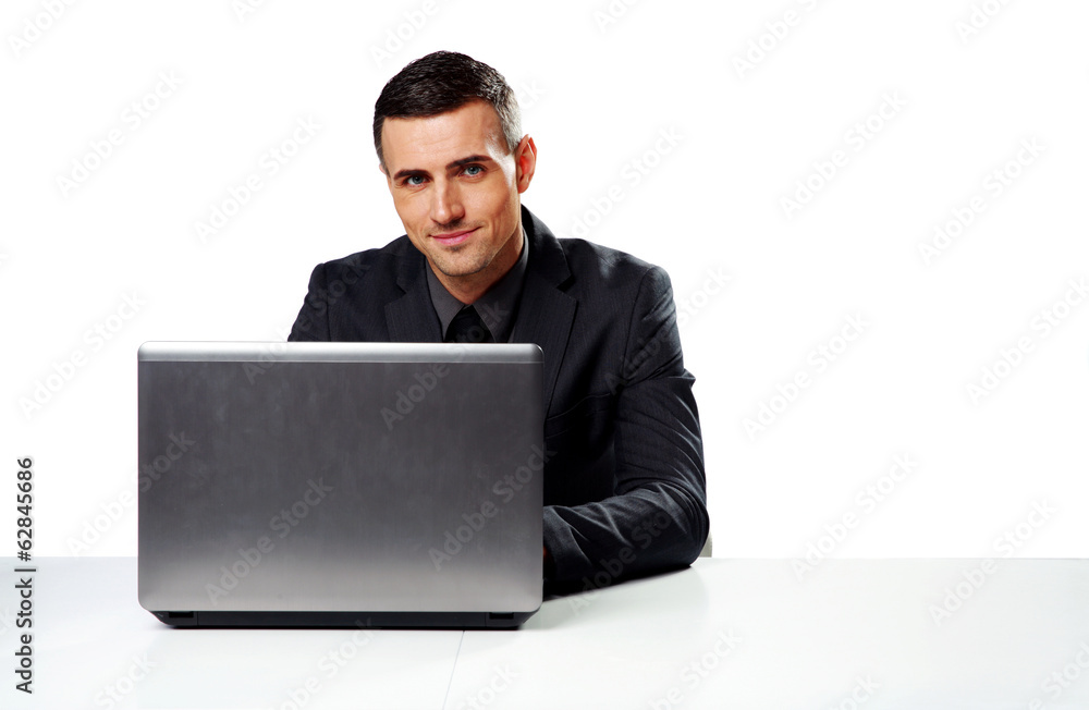 Happy businessman sitting at the table with laptop Happy businessman sitting at the table with laptop