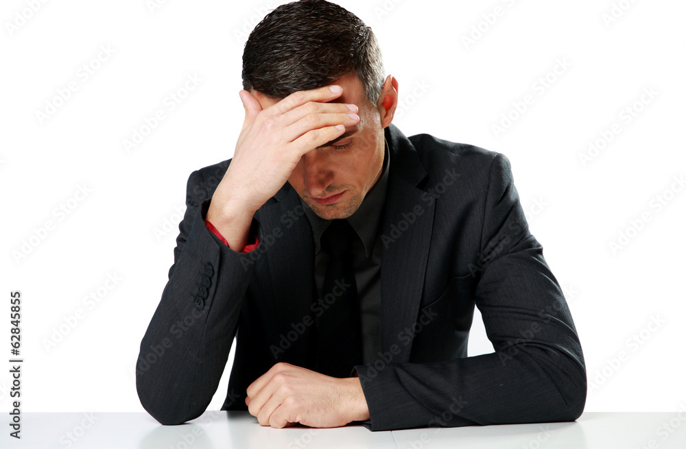 Depressed businessman sitting at the table Depressed businessman sitting at the table