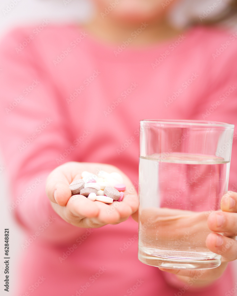 Hand with pills and glass of water Hand with pills and glass of water