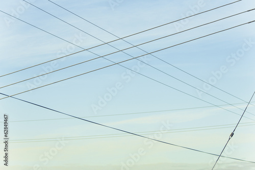 Power lines overhead, criss crossing in the air, at Belridge in California. photo
