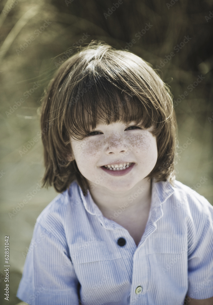 Young boy with brown hair and freckles, wearing blue shirt. Young boy with brown hair and freckles, wearing blue shirt.