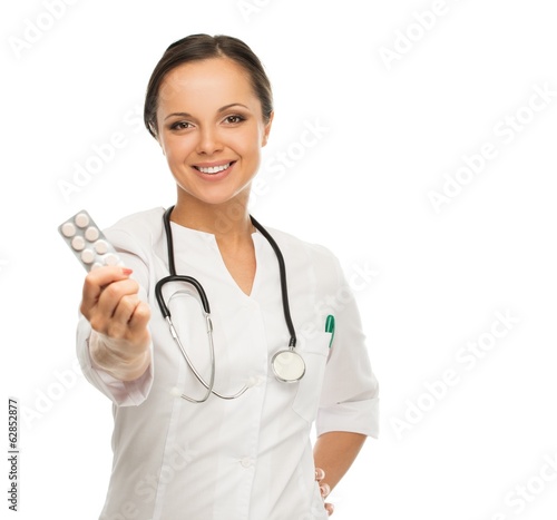 Young positive brunette doctor woman holding pills 