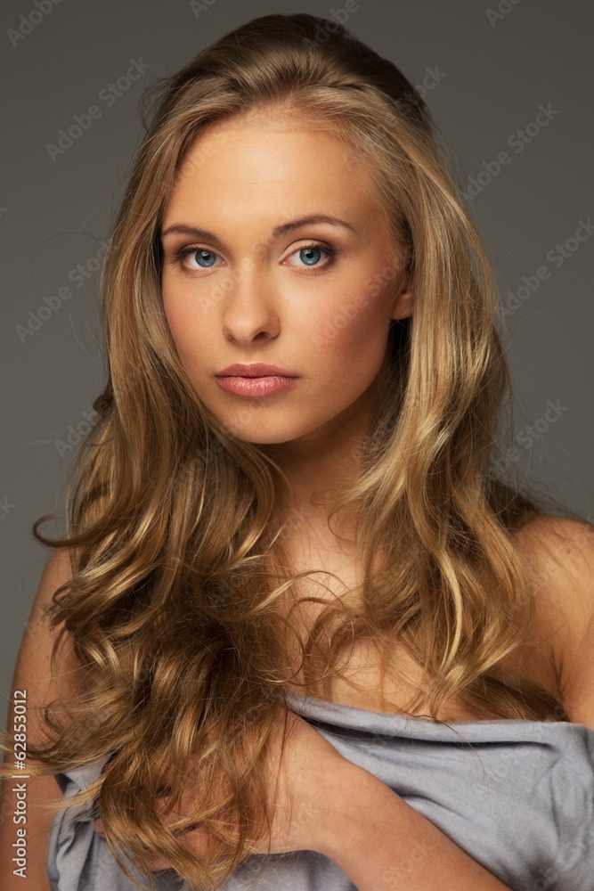 Positive young woman with long hair and blue eyes Positive young woman with long hair and blue eyes