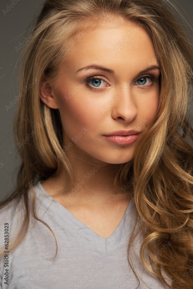 Positive young woman with long hair and blue eyes