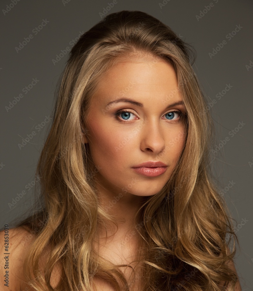 Positive young woman with long hair and blue eyes