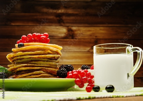 Healthy breakfast with pancakes, fresh berries and milk