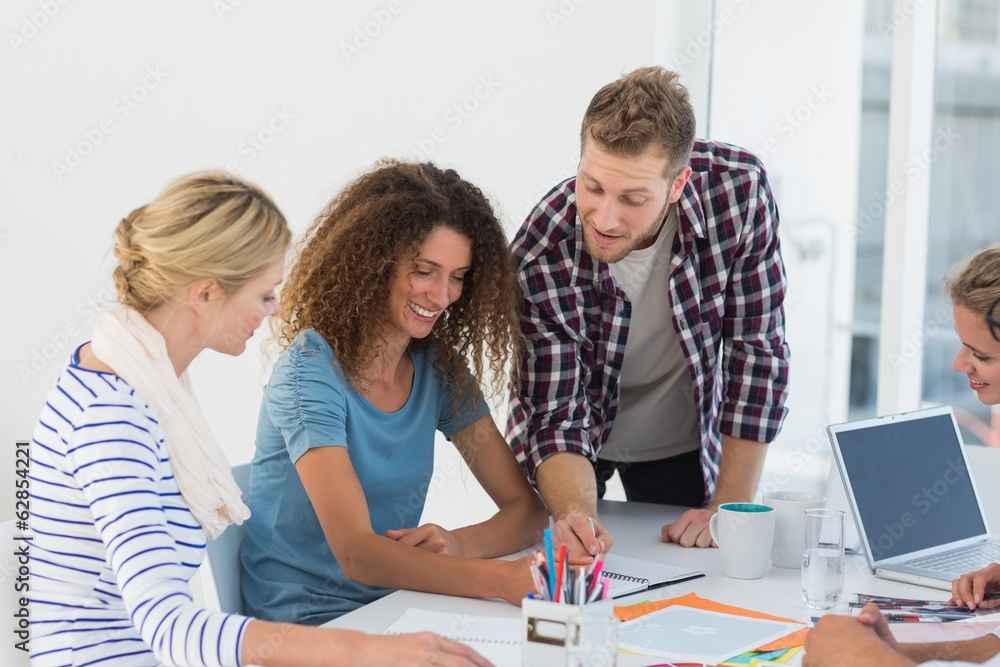 Young happy design team brainstorming together Young happy design team brainstorming together