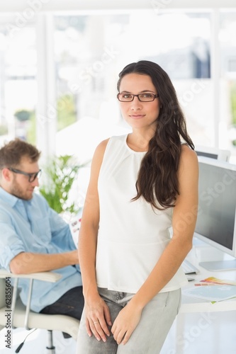 Beautiful designer smiling at camera leaning on desk Free Download Beautiful designer smiling at camera leaning on desk - GFXLoad