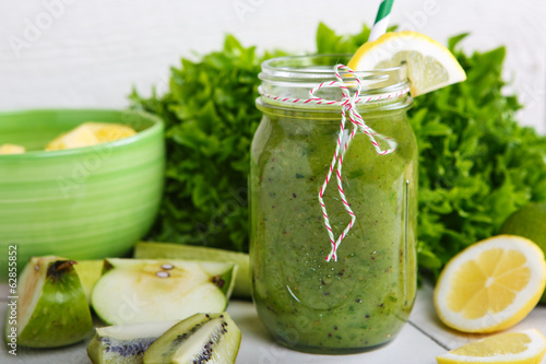 Fresh organic green smoothie with salad, apple, cucumber, pineap