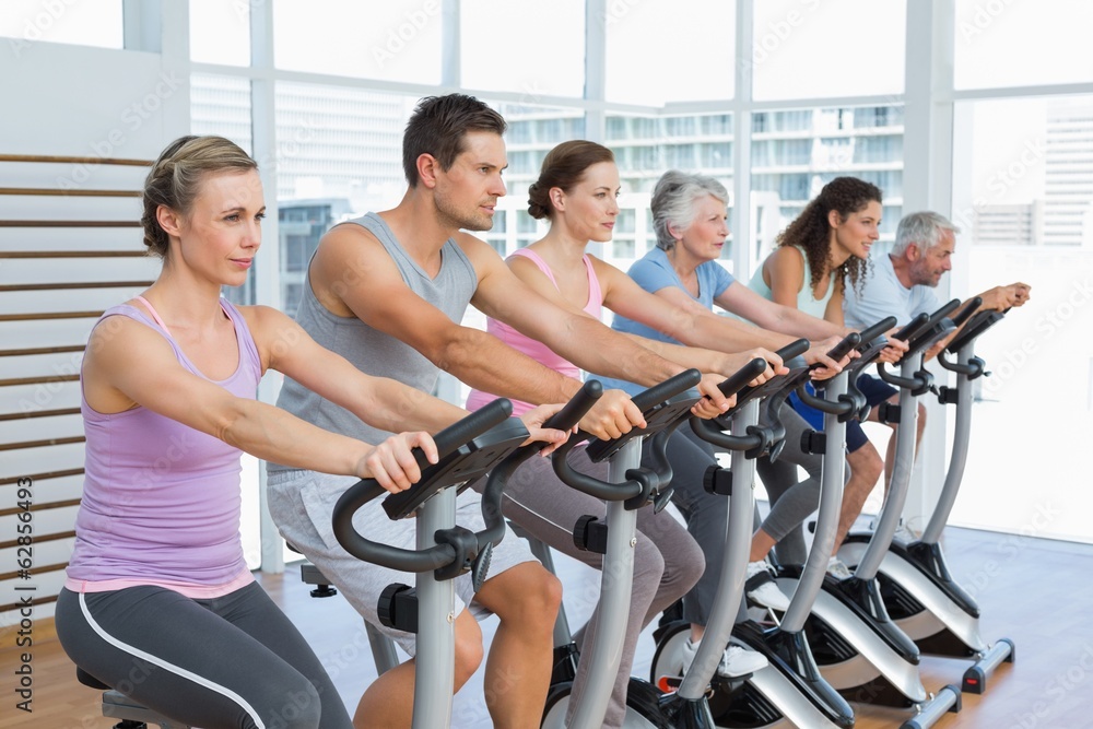 Determined people working out at spinning class Determined people working out at spinning class