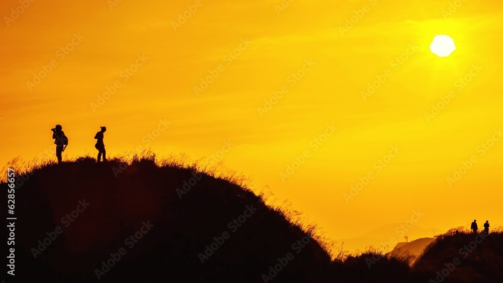 silhouette of traveller on top of mountain when sunset