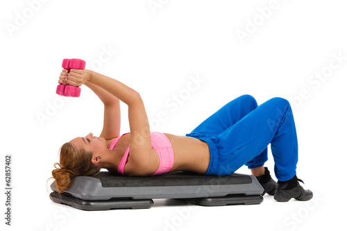 Female Exercise On Aerobic Step With Hand Weights