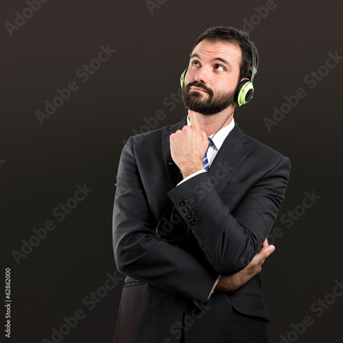 Young businessman listening music