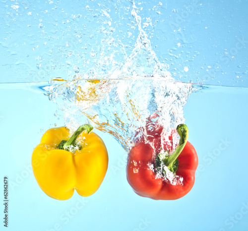 red and yellow pepper splashed into water