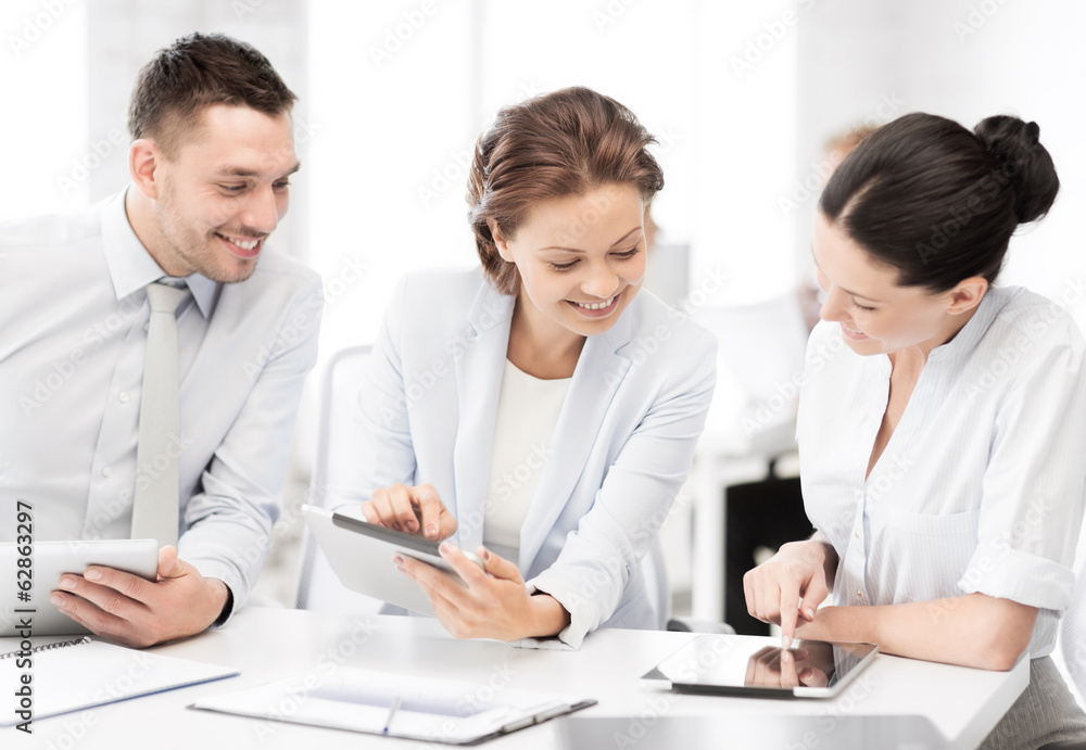 business team working with tablet pcs in office business team working with tablet pcs in office