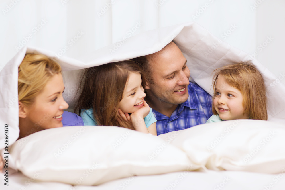 happy family with two kids under blanket at home happy family with two kids under blanket at home